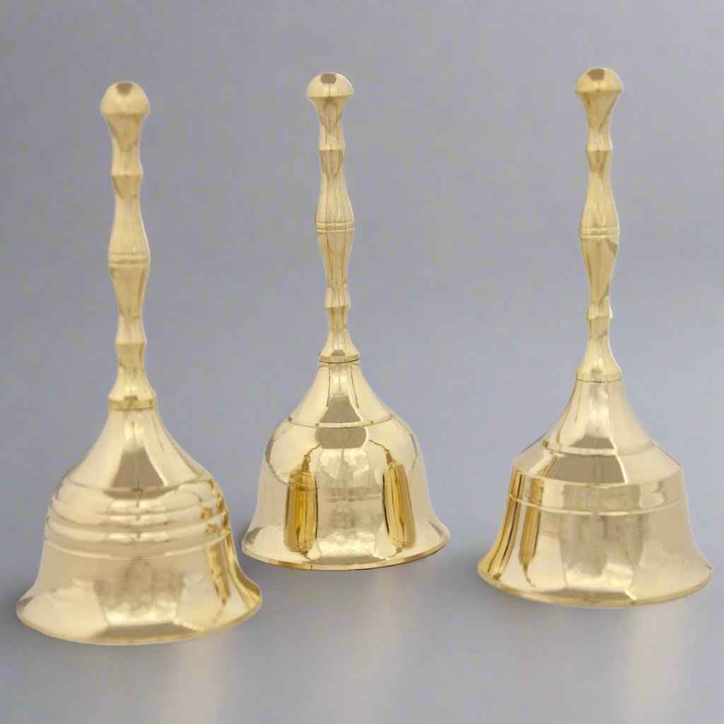 Three polished brass handbells with different handle and bell designs