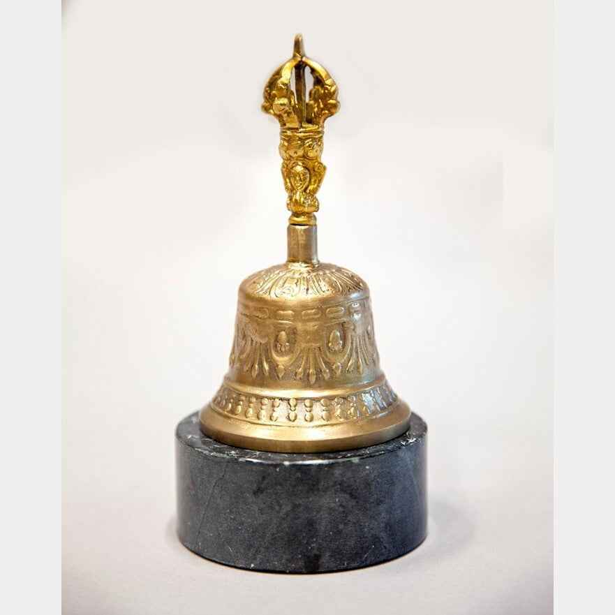 Bell Bazaar Tibetan-style bell with a decorated handle, shown on a display stand