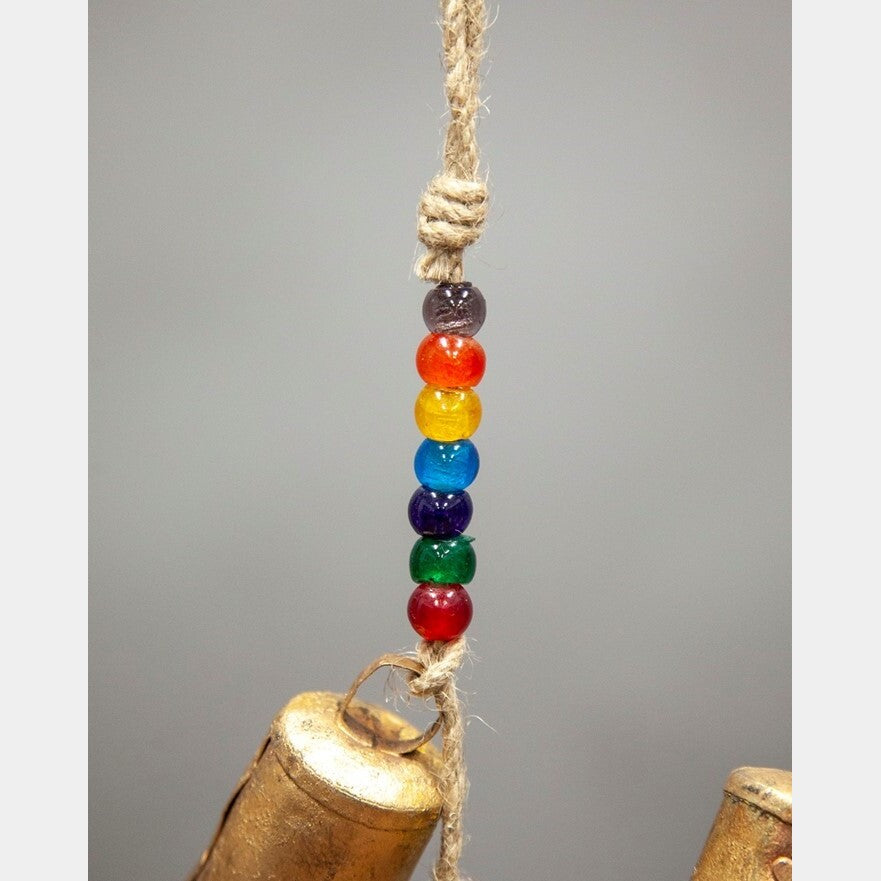 Close-up of colorful chakra beads and natural jute chime