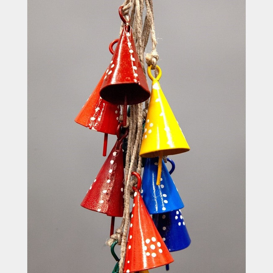 Close-up of painted tin cone bells on rustic natural jute strand