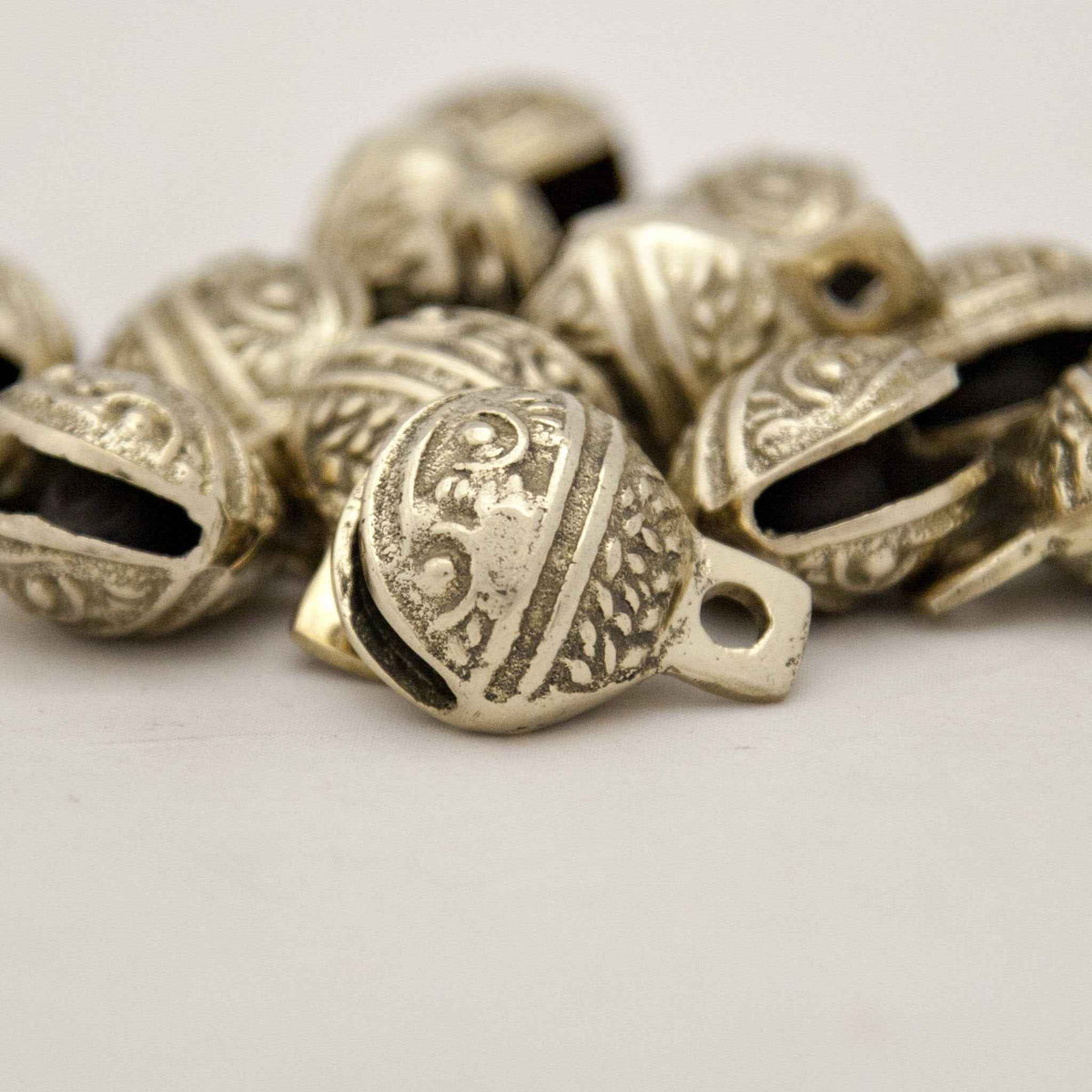 Dozen Single-Cut Embossed Brass Bells